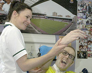 Occupational therapy arm exercises with a patient with a brain injury